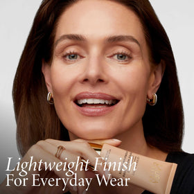 LAURA GELLER fingertip blending moisturizer onto skin demonstrating easy application