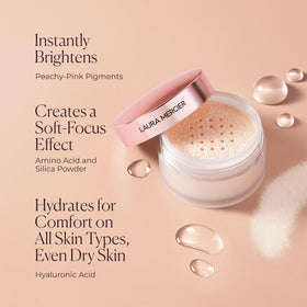 Laura Mercier jar next to credit card to show compact size and travel convenience