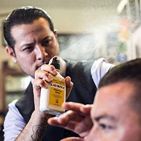 Layrite grooming spray used by barber prepping client hair for fuller, easier styling