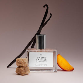Le Monde Gourmand 30ml next to coin for size comparison and travel-friendly benefit
