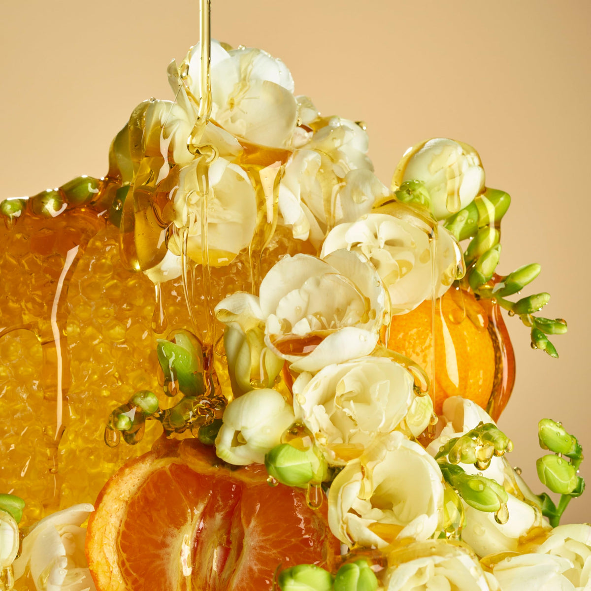 Le Monde Gourmand ingredients flatlay with honey and orange reflecting gourmand freshness