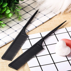 Leinuosen comb held in hand showing compact size for comfortable professional use