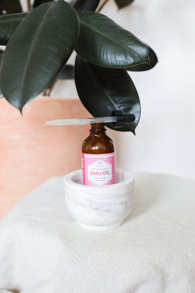 Leven Rose bottle beside a ruler showing 4 oz scale for sizing and travel planning