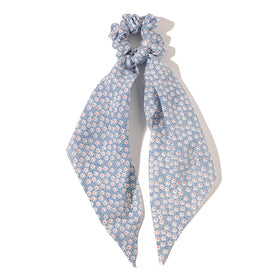 LFOUVRE scrunchie worn as wrist accessory showing dual-purpose fashion and convenience
