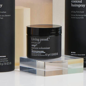 Living Proof Amp Texture Volumizer applied in hair during styling, delivering touchable lift and texture