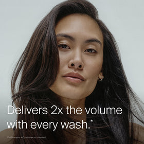 Living Proof conditioner being applied to mid-lengths for detangling benefit