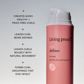 Living Proof applying product to damp curls for even distribution and definition