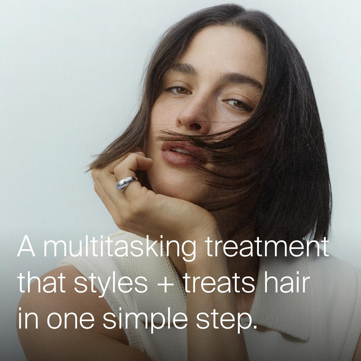 Living Proof applying treatment to damp hair for smoother blow-dry
