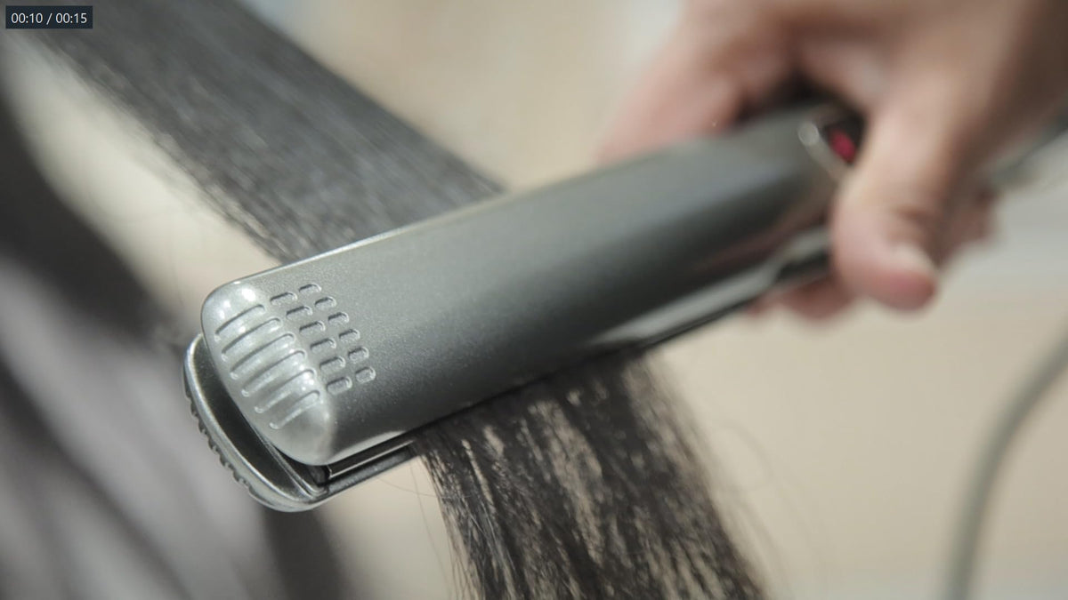 Lizze in hand to show scale and comfortable grip for long styling sessions