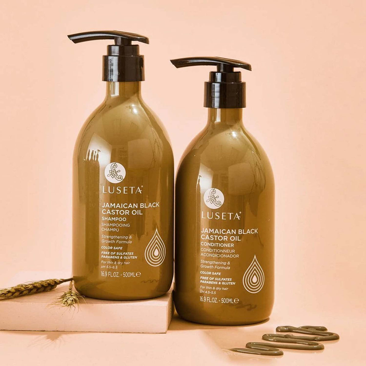 L LUSETA bottles beside castor beans showing natural oil-sourced benefit