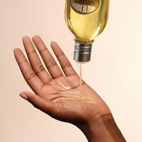 L'OCCITANE Almond milky lather in hand demonstrating creamy cleansing benefit