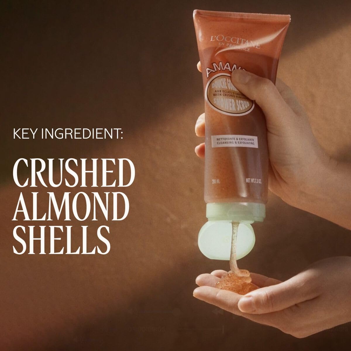 L'Occitane almond shower scrub gel texture close-up showing gentle exfoliant and smooth rinse