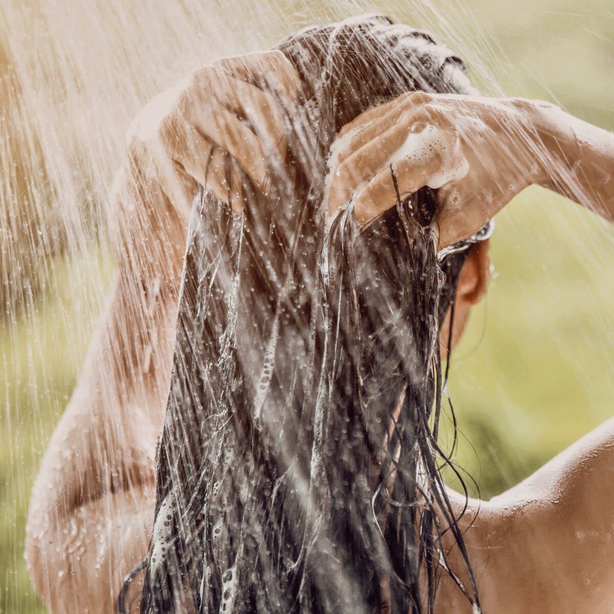 Lifestyle shelf scene with L'Occitane shampoo evoking Provençal freshness benefit