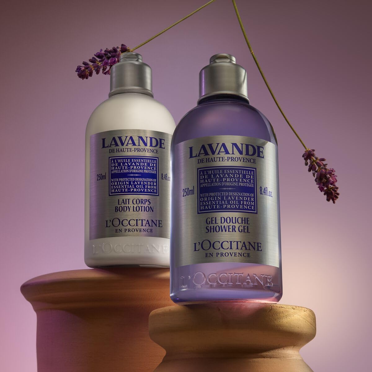 L'OCCITANE bottle next to common items showing 8.4 fl oz size and travel-friendly benefit
