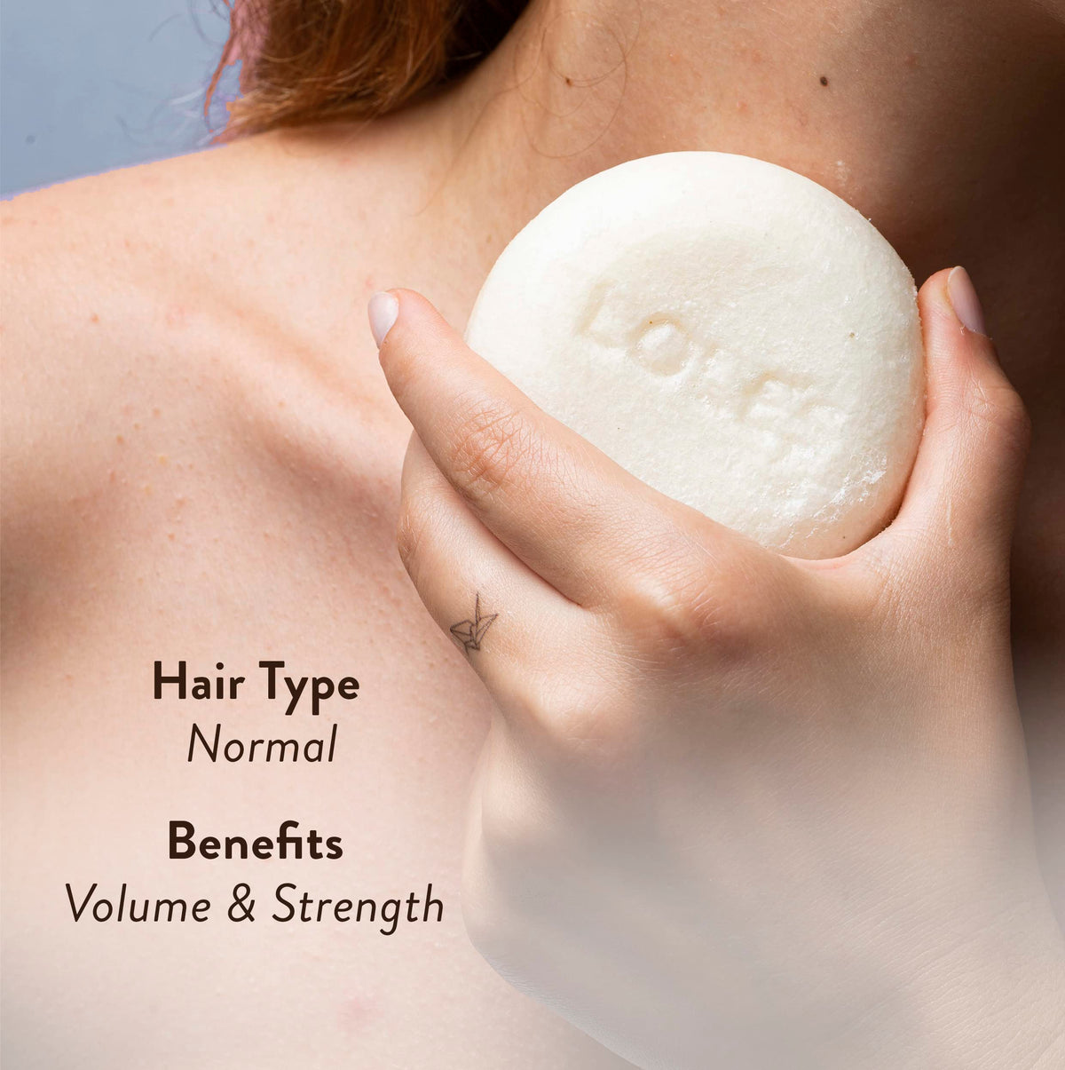LOLE'S shampoo bar in hand illustrating travel-ready convenience