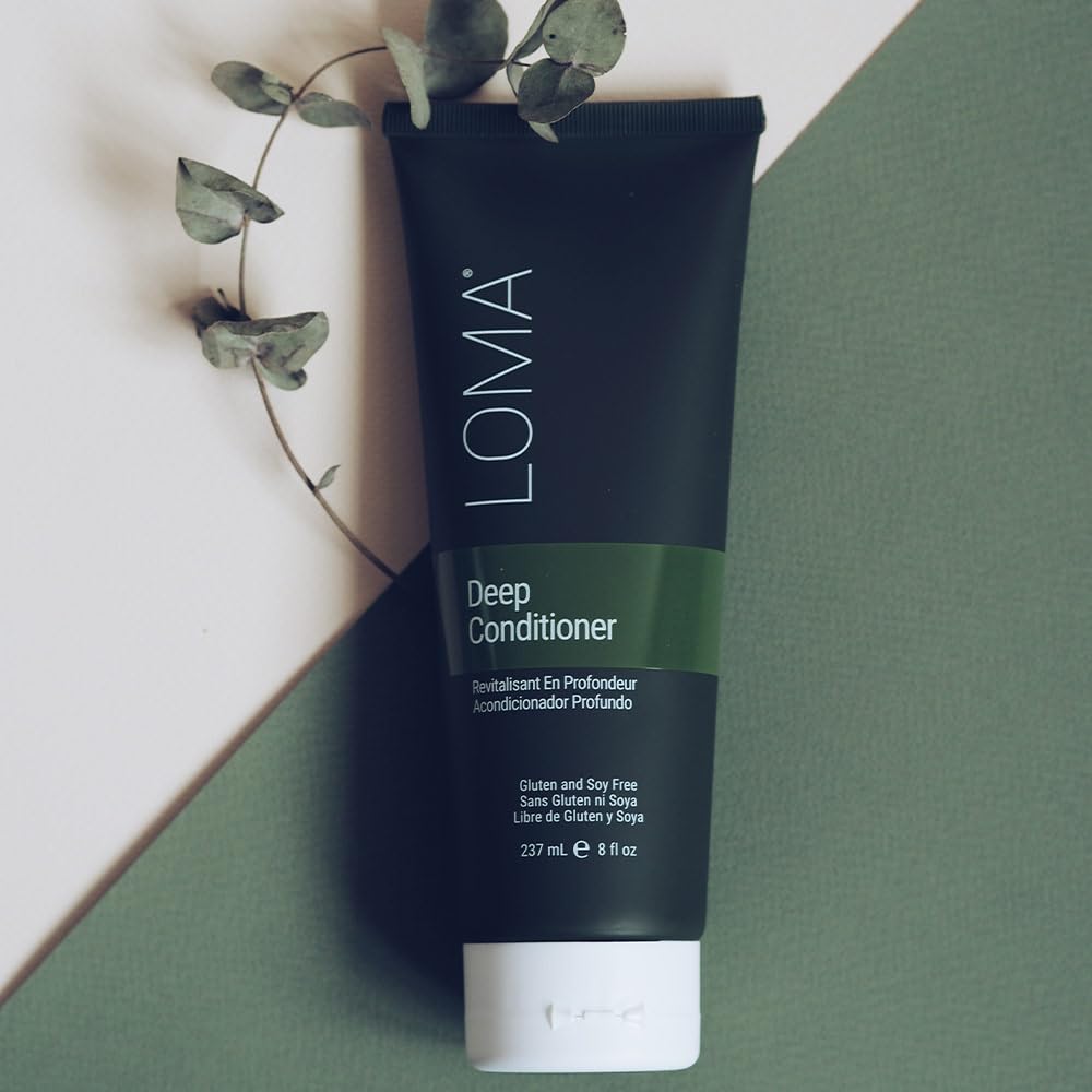 LOMA deep conditioner bottle next to baobab fruit showing natural ingredients and ingredient clarity
