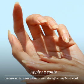 LONDONTOWN bottle staged in manicure setting showing use as base coat or treatment