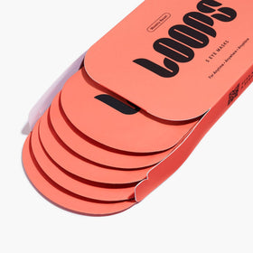 LOOPS eye mask held in hand to show size and application ease