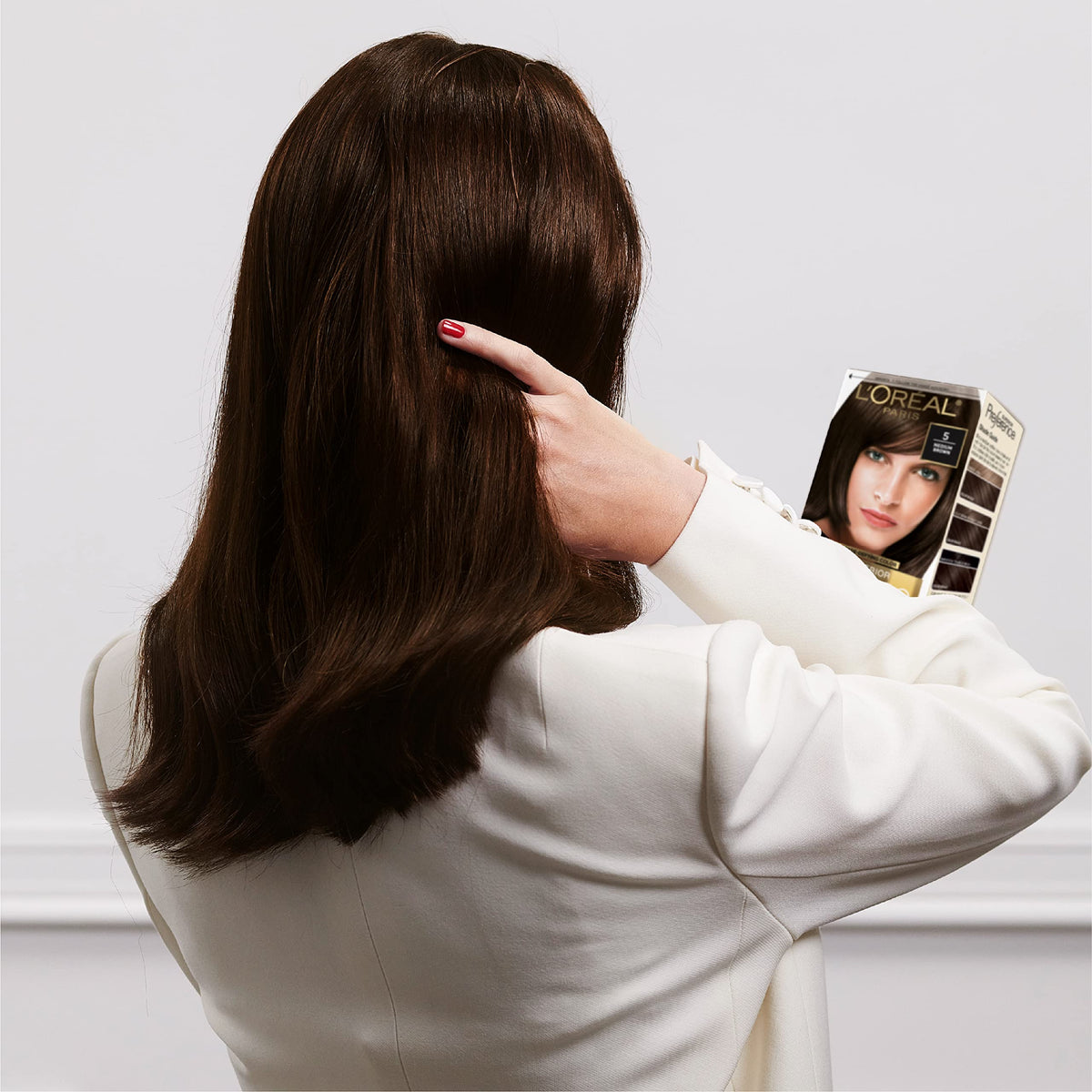 L'Oreal Paris after-color results on model, displays cool ultra light ash brown