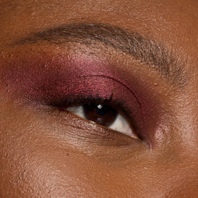 L'Oreal Paris stick inside a makeup bag illustrating on-the-go touch-up convenience