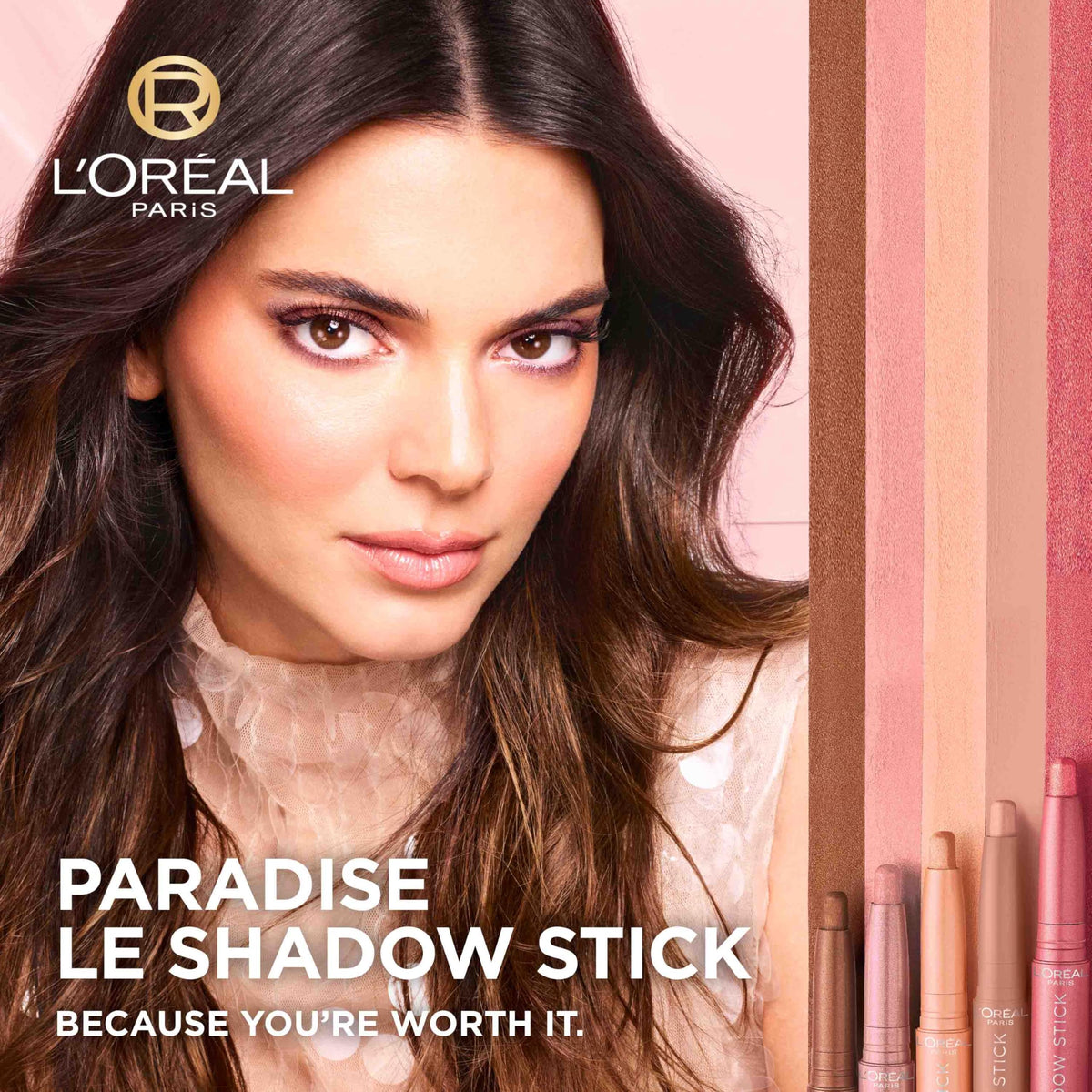 L'Oreal Paris shadow stick next to fingers illustrating compact size and travel-friendly benefit