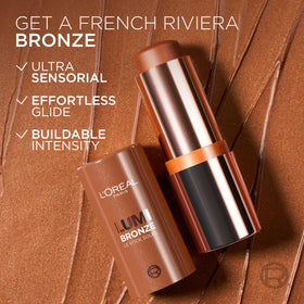 L'Oreal Paris applying bronzer to cheek in mirror for instant sun-kissed glow