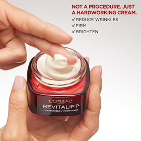 L'Oreal Paris cream being applied to cheek showing lightweight absorption