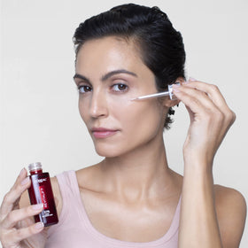 L'Oreal Paris 30ml bottle next to common objects to show compact size for travel