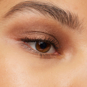 L'Oréal Paris product in hand to show scale and travel-ready convenience for on-the-go touch-ups.