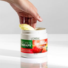 L'OREAL TECHNIQUE size comparison next to a hand showing product volume and travel convenience