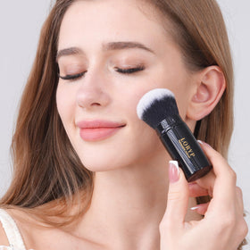 LORYP brush dabbing loose powder to set makeup and reduce shine