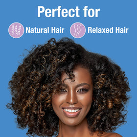 Applying Lottabody spray to damp hair for detangling and prep