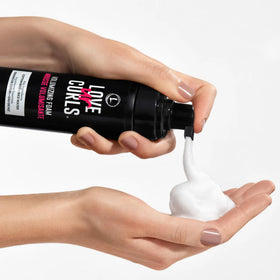 Love Ur Curls next to a hand showing 7.3 fl oz scale
