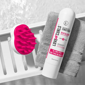 Love Ur Curls 8.5oz bottle next to a ruler showing product size