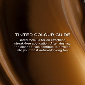 Model applying Loving Tan on arm shows even coverage and natural result