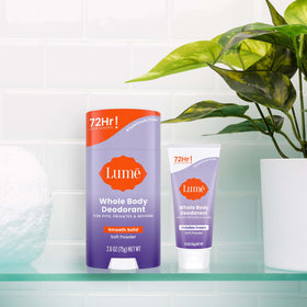 Model applying Lume stick to underarm demonstrating discreet all-day protection