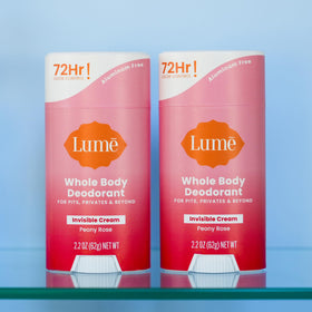 Lume on bathroom counter with peony accent conveying light floral scent