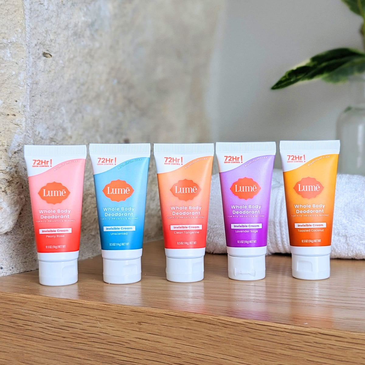 Lume mini tubes arranged on bathroom shelf conveying everyday use and quick access