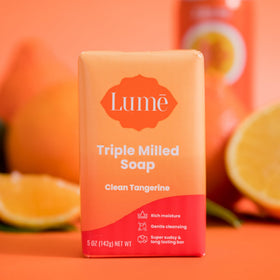 Lume 5 ounce bar in hand for scale and easy daily use benefit