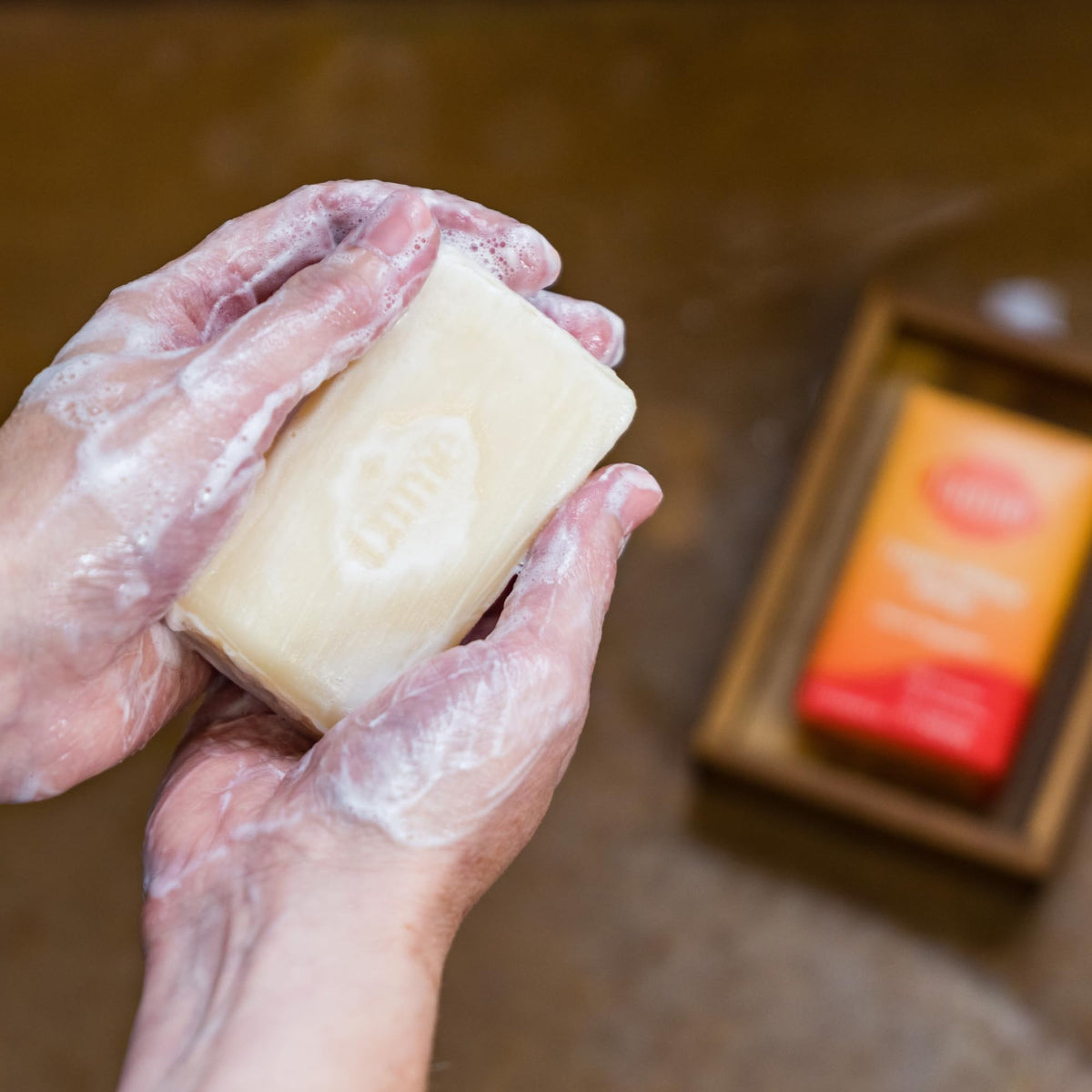 Lume soap styled with tangerine fruit showing bright citrus scent benefit