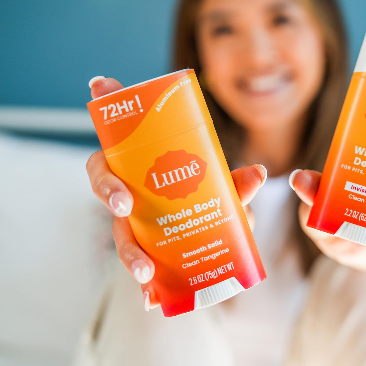 Applying Lume stick to underarm for targeted odor control and comfort