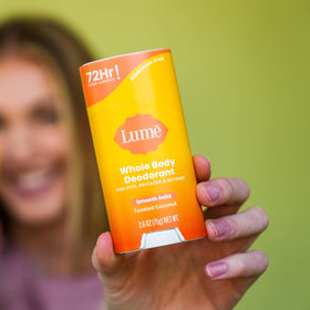 Lume stick used on foot demonstrating whole-body odor control and fresh feeling
