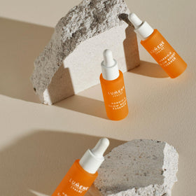 Lumene bottle on vanity staged with towel for everyday skincare routine