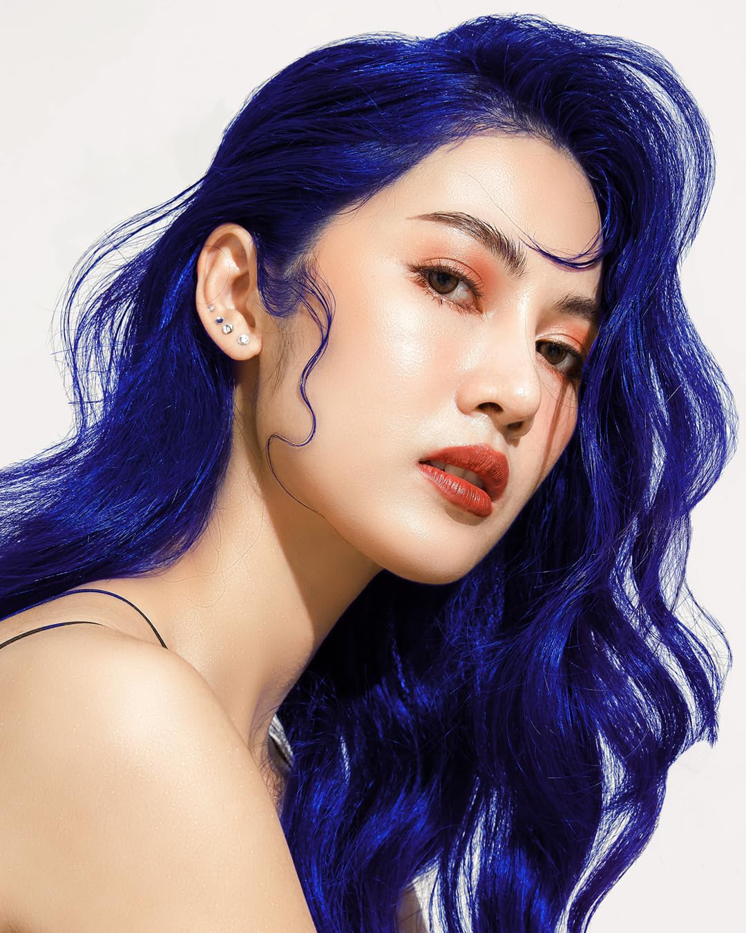 Lunar Tides lifestyle studio portrait showcasing styled navy hair for inspired looks