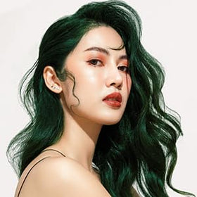Lunar Tides model in studio with Juniper green hair, showcases bold wearable color