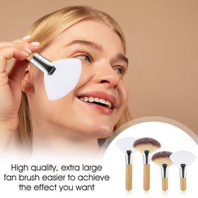 Hand-held Lusofie brushes beside a coin for scale showing travel-friendly compact size