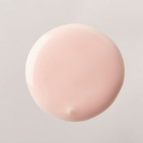 Luster's pink oil moisturizer in hand for scale highlighting large 32 oz value