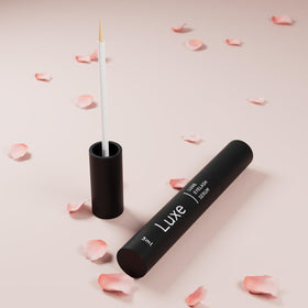 LUXE clear serum texture drop highlighting lightweight absorbent benefit