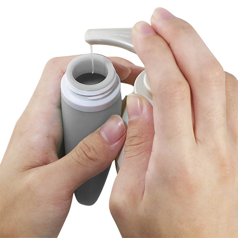 LYOB bottle held in hand for scale to show compact TSA-approved size
