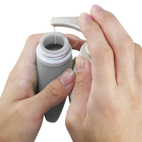 LYOB bottle held in hand for scale to show compact TSA-approved size
